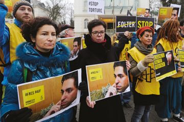 An Amnesty International vigil for Raif Badawi in Vienna, Austria. January 2015. The Saudi arabian government sentanced Raif Badawi to 10 years in prison and 1,000 lashes in May 2014. He was convicted of insulting Islam through his writings and on his website, which was set up to encourage public debate